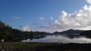 image of pond with mountains and clouds