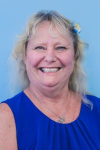 Woman smiling and wearing a blue shirt