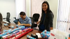 20171208_125051 Man and woman in front of rolls of wrapping paper