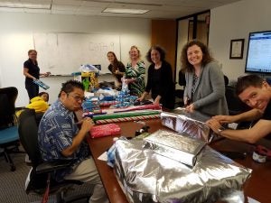 20171208_125943 Group photo of people wrapping gifts