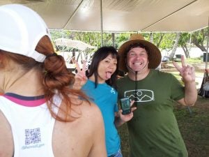 man and woman giving peace sign