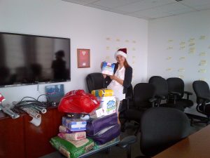 woman in santa hat holding a gift