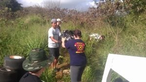 Group of people passing garbage in a line