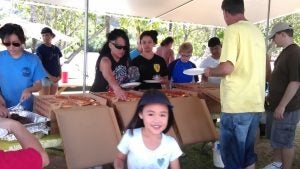 People lining up for pizza