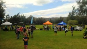 imag4355 tents on a green lawn with people standing around