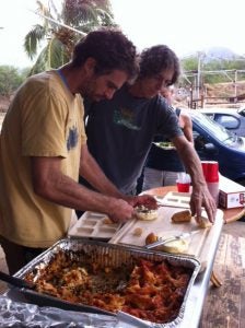 image13 two men serving food in trays