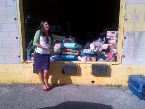 woman in front of piles of dog food