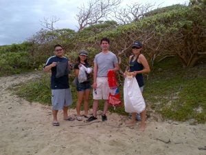 img-20130302-00092 four people holding trash