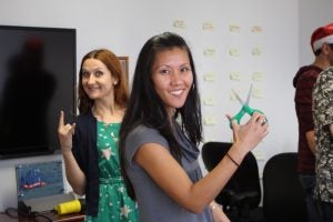 woman holding scissors and smiling