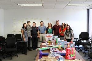 group of people posing with presents