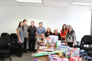 group of people posing with presents