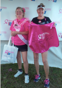 j Two women wearing pink capes