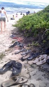 slippahs shoes lined up on beach