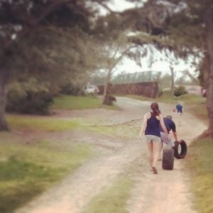 tires woman rolling a tire