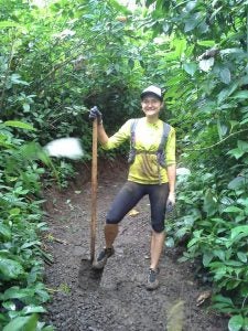 trail2 woman posing next to shovel